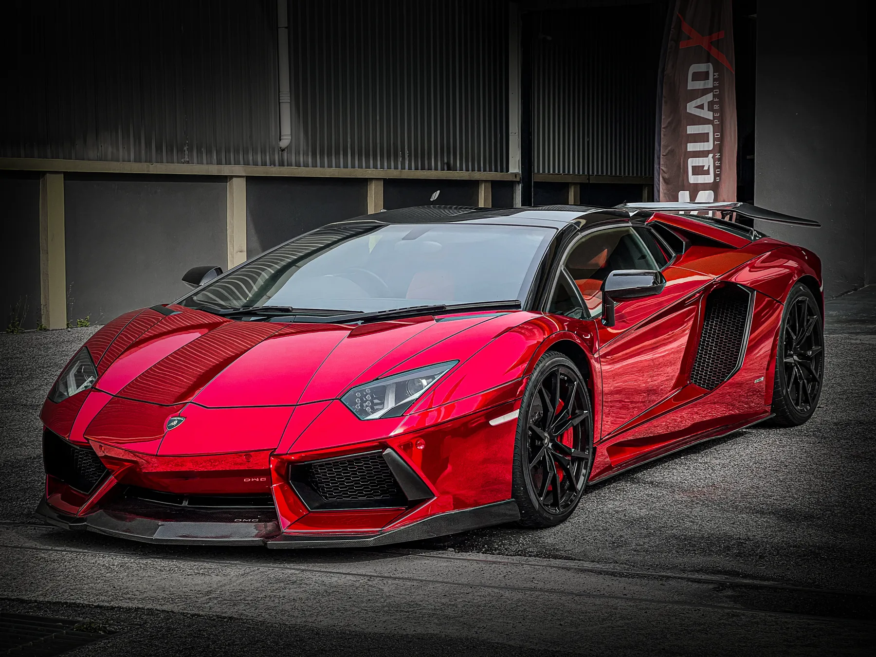 Red chrome-wrapped Lamborghini Aventador in the workshop